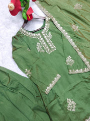 Green embroidered traditional outfit on a white background