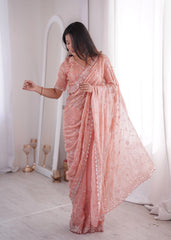 Woman wearing a pink saree with a white background
