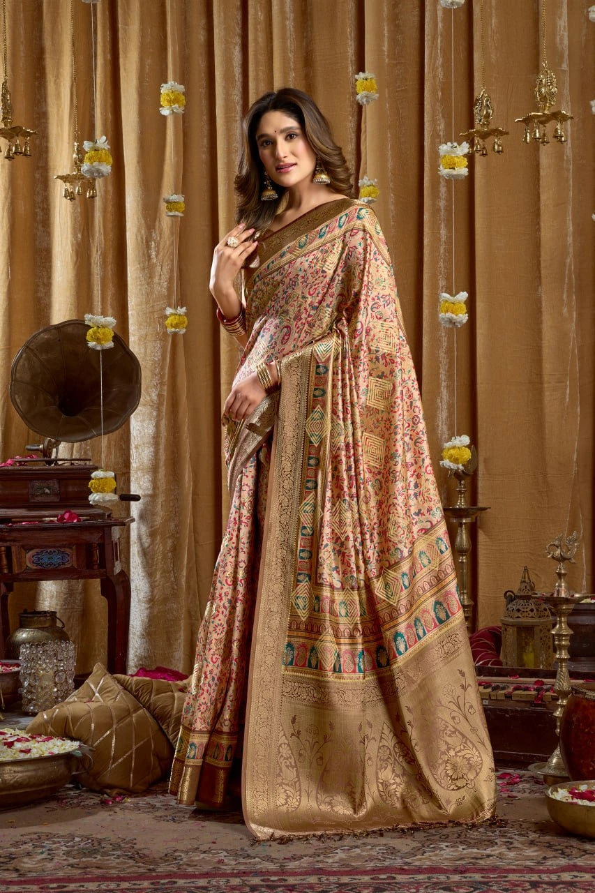 Woman in a traditional embroidered saree standing in an ornate room with decorative elements.