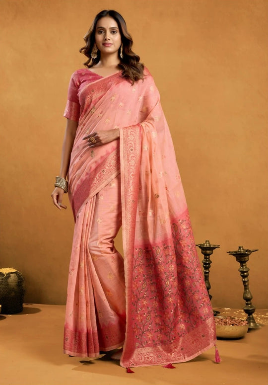 Woman wearing a pink saree with a traditional setting