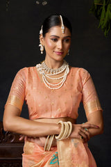 Woman in traditional attire with jewelry against a dark background