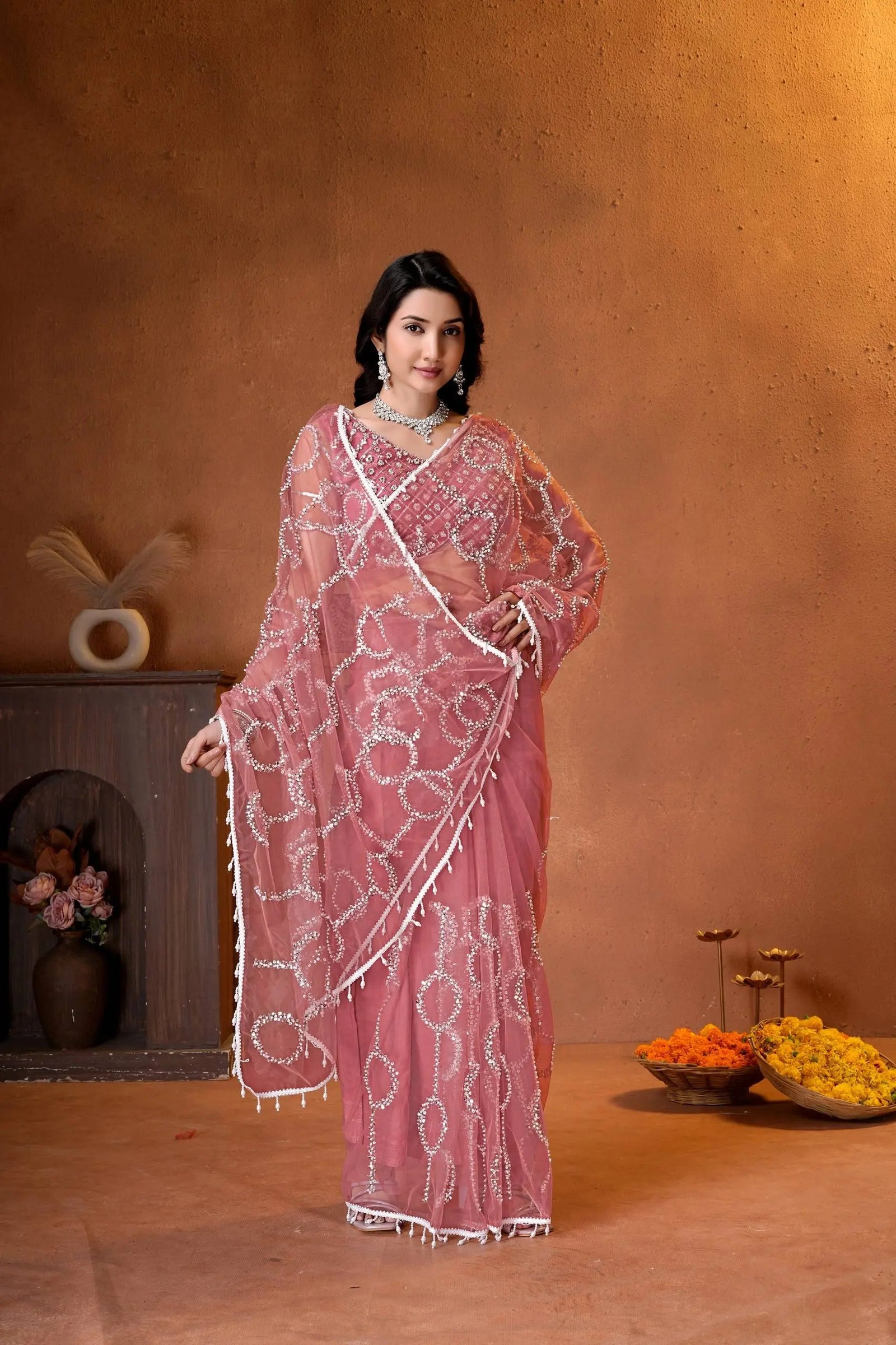 Designer party wear saree featuring a matching embroidered blouse, delicate beadwork, and graceful drape for weddings and celebrations.