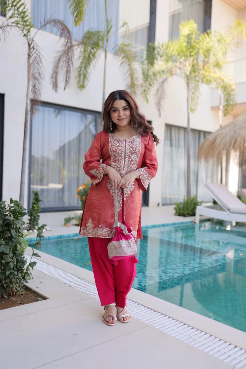 Woman in traditional outfit by a poolside with modern building and plants in the background