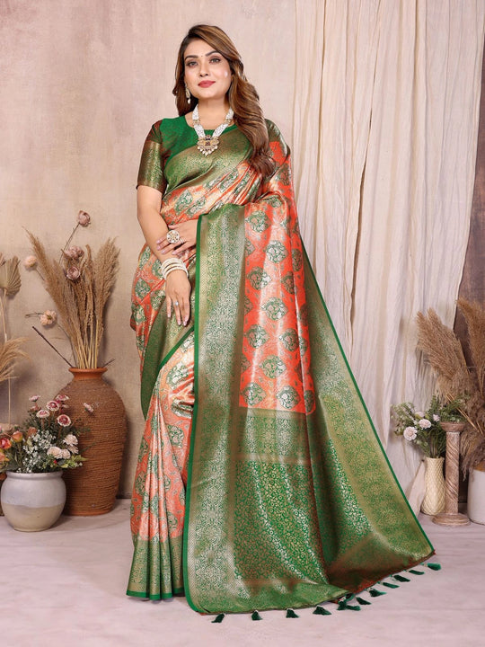 Woman wearing a green and orange saree with a neutral background
