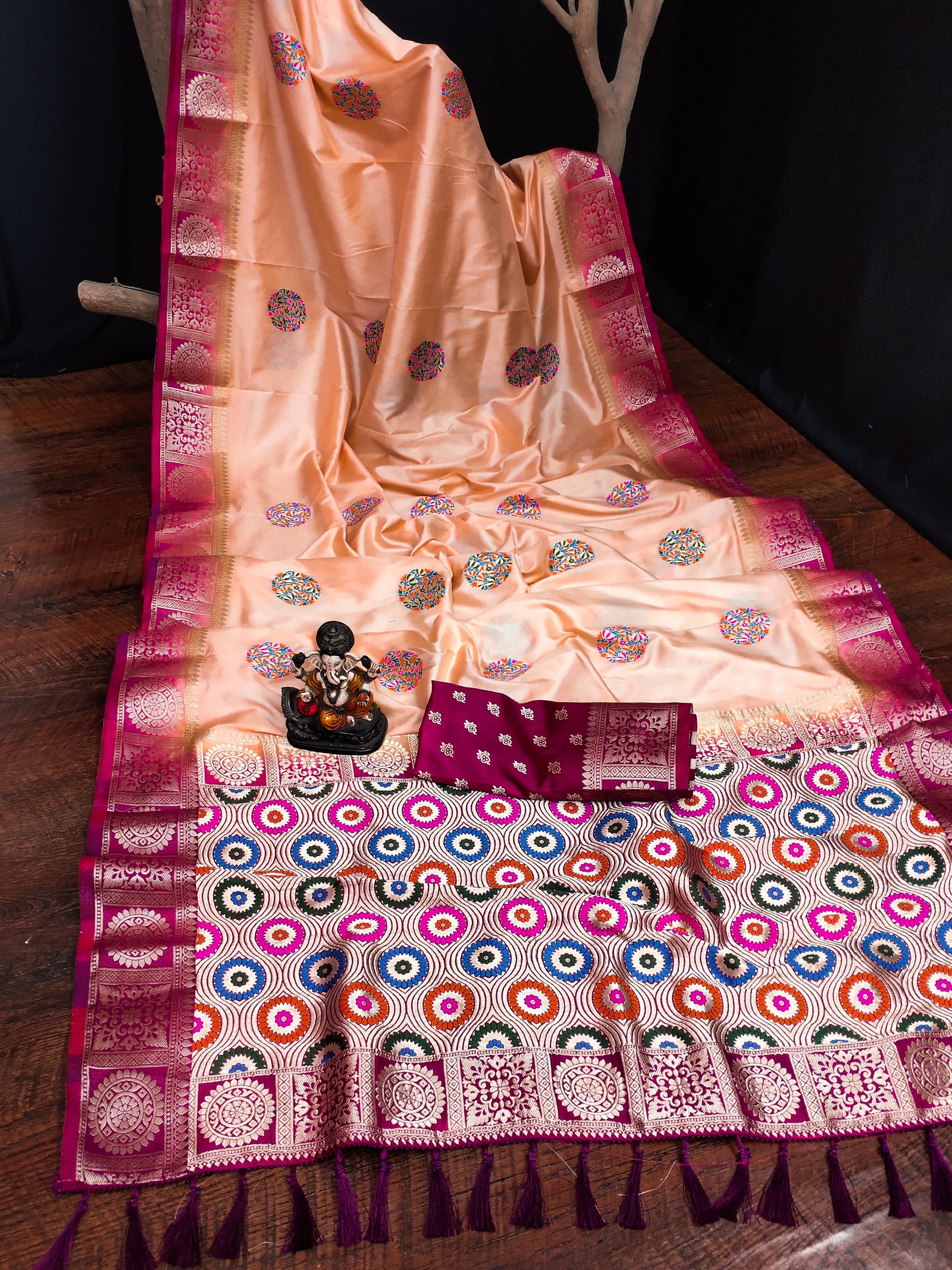 Traditional saree with intricate patterns on a wooden surface