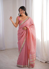Woman wearing a pink saree with a white background