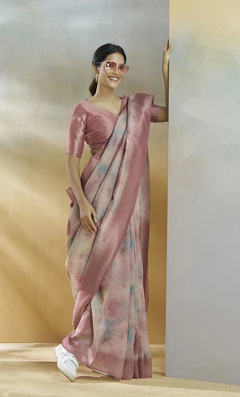 Woman wearing a pink saree with a blurred background