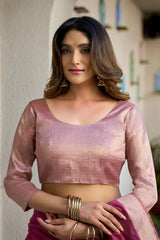 Woman wearing a pink blouse with a blurred background