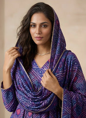 Woman wearing a purple patterned shawl against a beige background