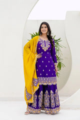 Woman in a purple traditional outfit with yellow dupatta against a white background
