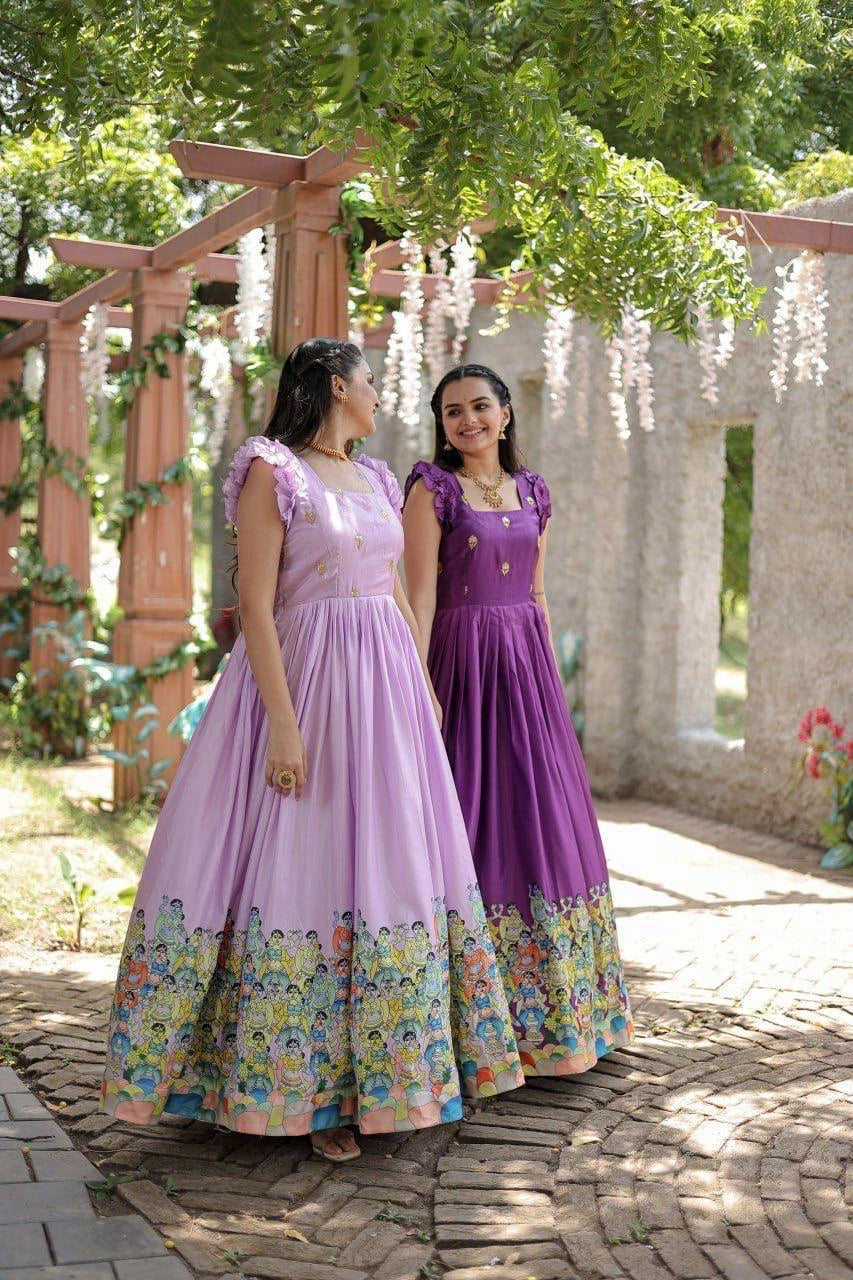 Two women in floral dresses standing outdoors under a wooden arbor with greenery.
