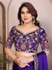 Woman wearing a purple embroidered saree with a floral pattern