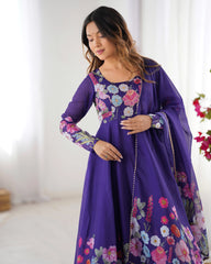 Woman wearing a purple dress with floral embroidery indoors.