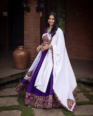 Woman in traditional outfit with a white dupatta standing outdoors.