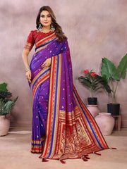 Woman wearing a colorful saree with a neutral background