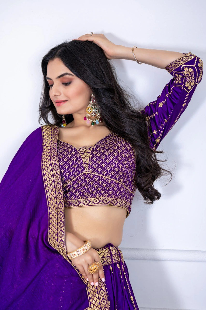 Woman wearing a purple traditional outfit with gold embroidery against a white background