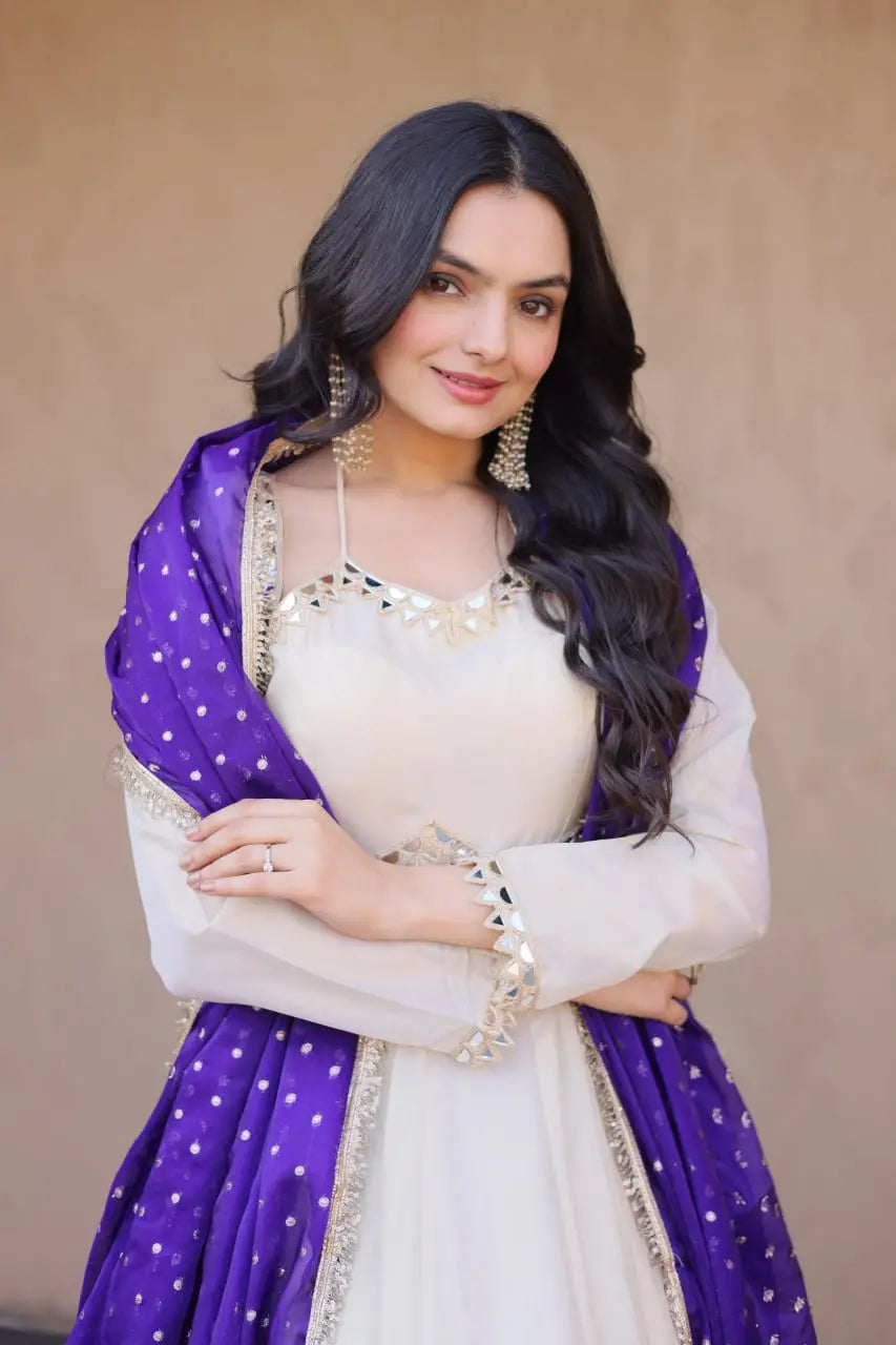 Woman wearing a white and purple traditional outfit with a beige background