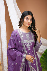 Woman wearing a purple traditional outfit with white embroidery against a beige background