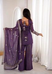Woman in a purple traditional outfit standing in front of a mirror.