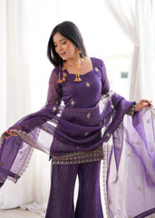Woman in a purple traditional outfit with a white background