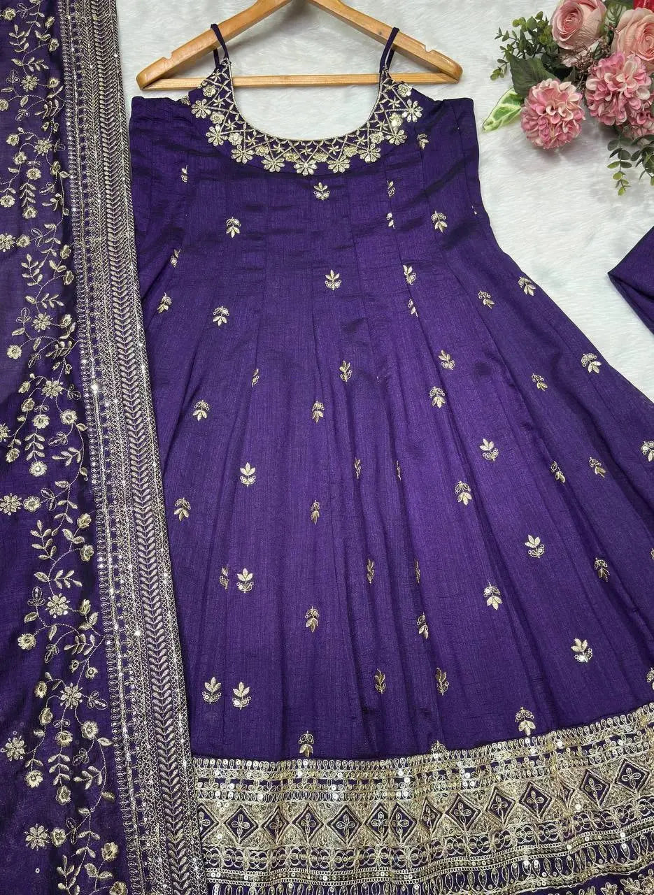 Purple embroidered traditional dress with floral decorations on a white background