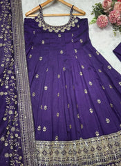Purple embroidered traditional dress with floral decorations on a white background