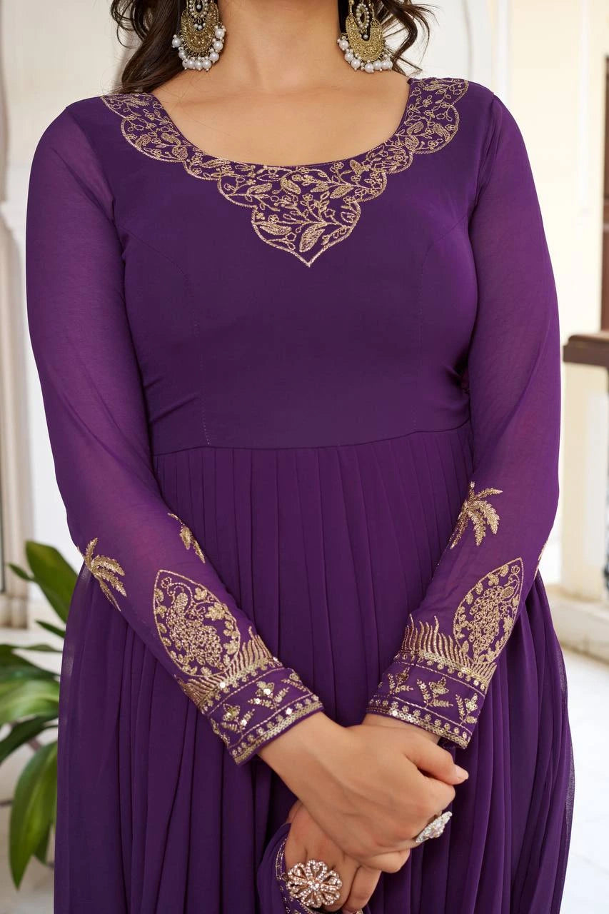 A close-up shot focusing on the neckline and sleeve embroidery. The gold zari work features delicate floral patterns, while the cuffs include small, shimmering sequins for added texture.