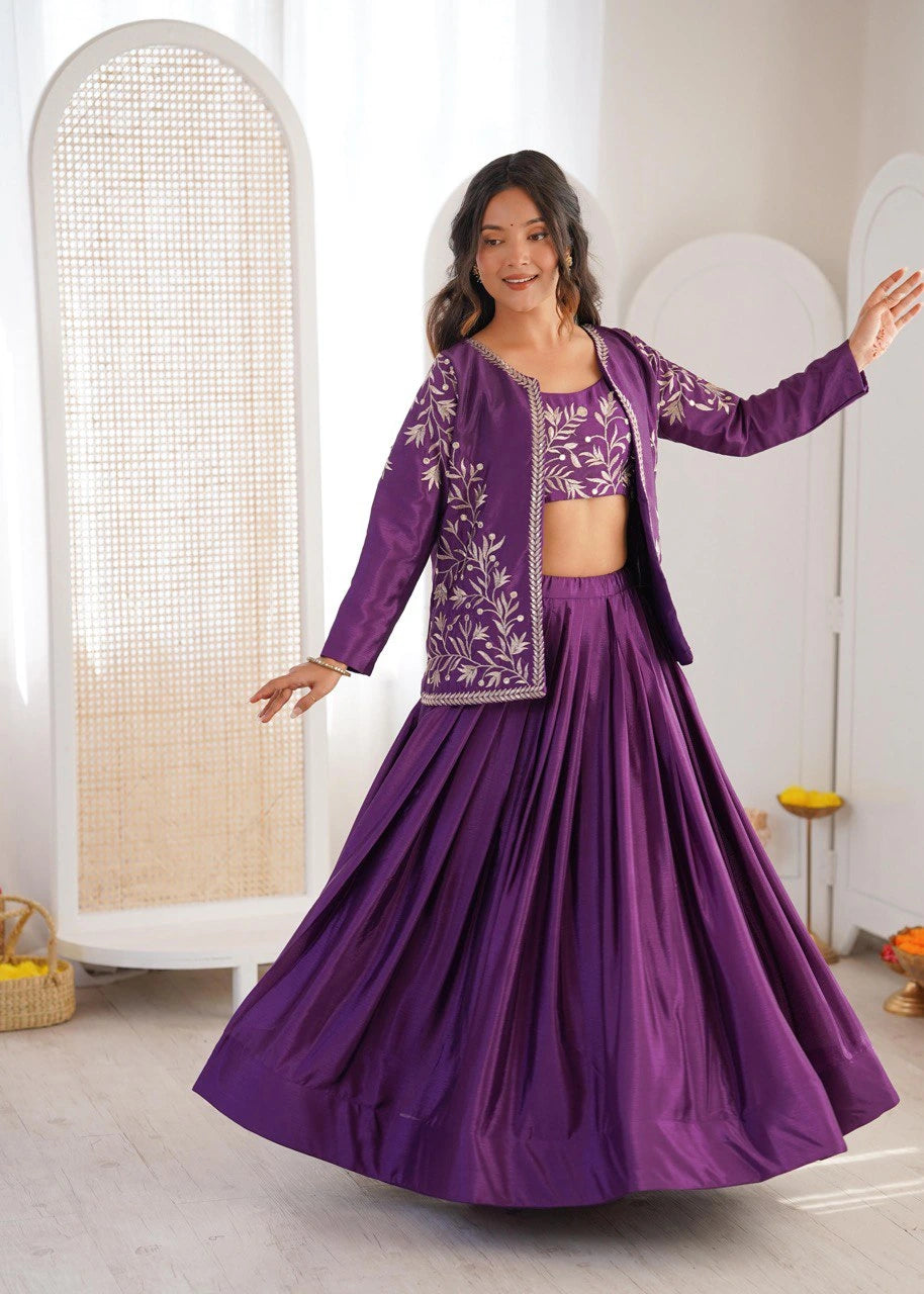 Woman in a purple traditional outfit with floral patterns in a minimalistic setting