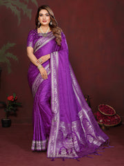 Woman wearing a purple saree with silver border against a dark background