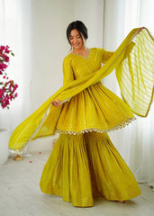 Woman in a yellow traditional outfit with a white background