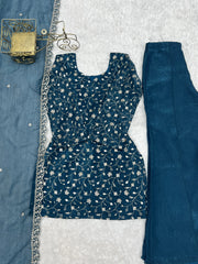Blue floral dress with matching pants on a textured white background