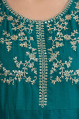 Teal dress with intricate silver embroidery