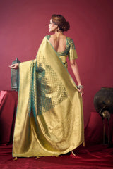 Woman in a gold and green saree against a red background