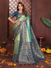 Woman wearing a traditional saree with intricate patterns in a decorative setting.