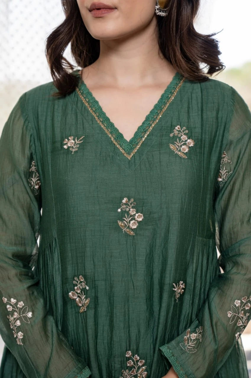 Features a graceful V-neckline, sheer sleeves, and matching dupatta for a festive look.