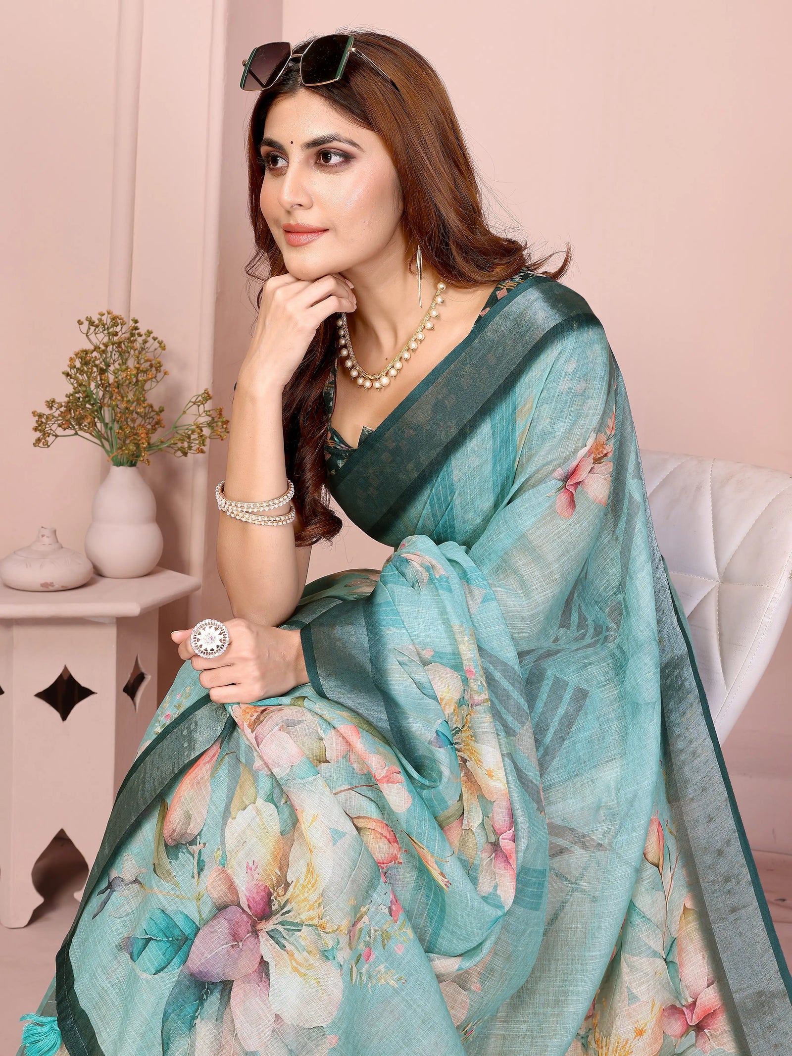 Close-up portrait of Tropical Green Digital Floral Print Saree showing soft watercolour lily print and dark teal border detail