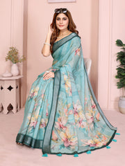 Tropical Green Linen Cotton Saree with Digital Floral Print draped in seated pose showing pallu and teal tassel border