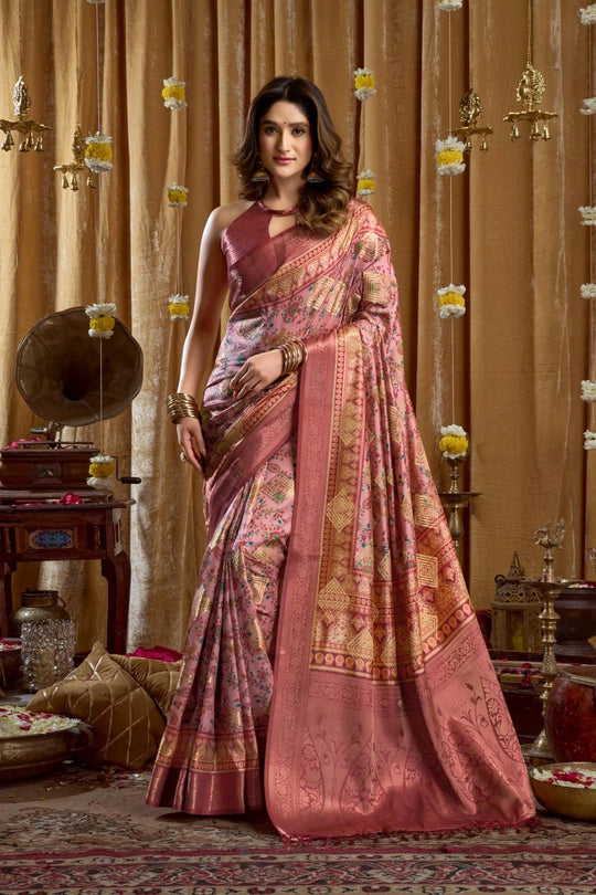 Woman in a traditional saree standing in a decorated room with vintage decor.