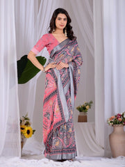 Woman wearing a pink and gray patterned saree with a white curtain background