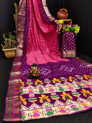 Colorful saree with intricate patterns on a dark background