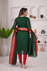 Woman wearing a green and red traditional outfit with a white background