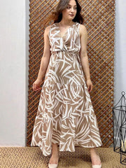 Woman wearing a patterned dress standing against a wooden lattice background