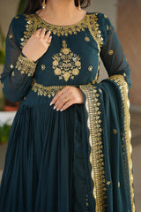 Teal outfit with gold embroidery on a blurred background