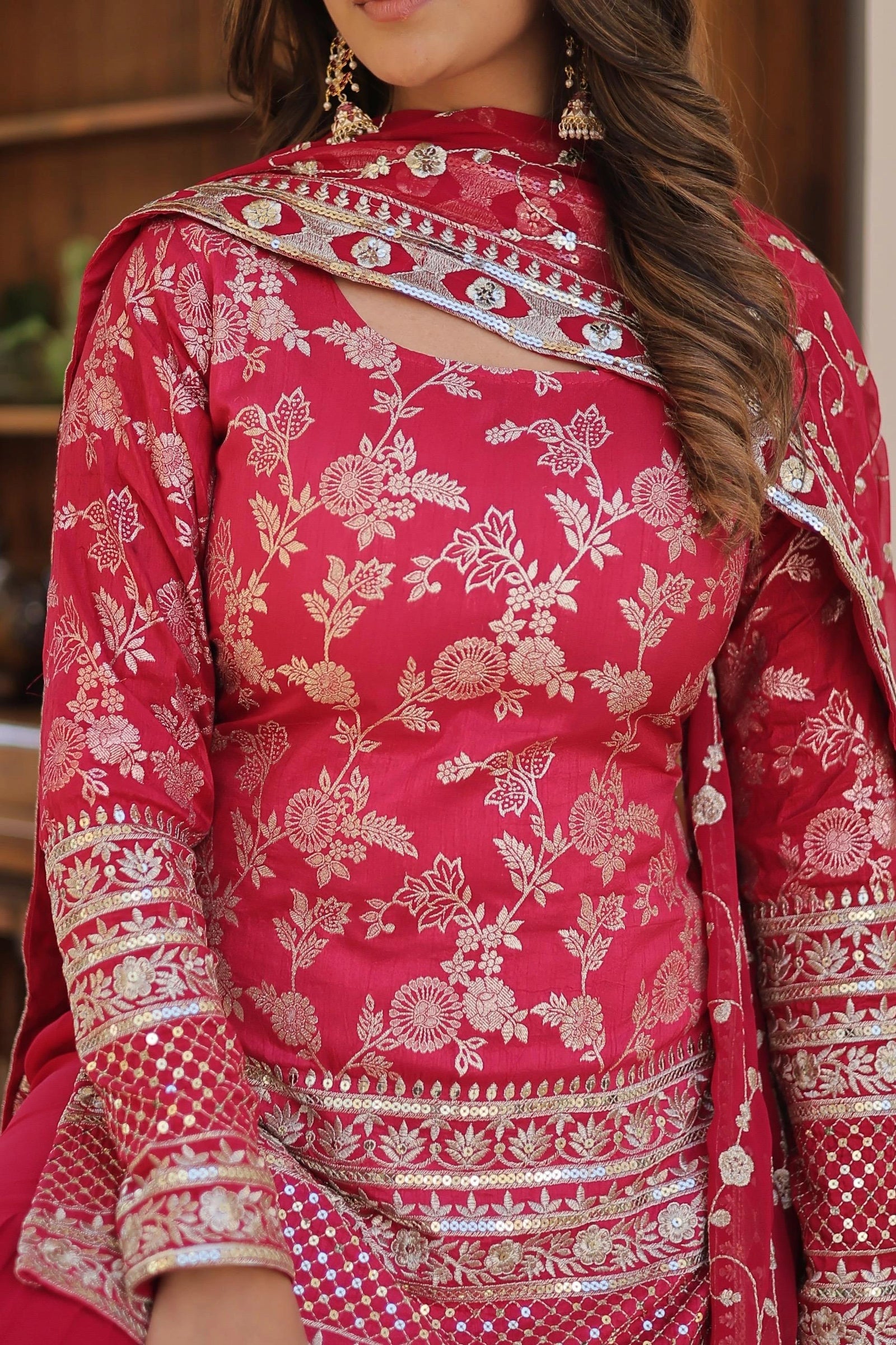 Red traditional outfit with floral patterns and intricate designs