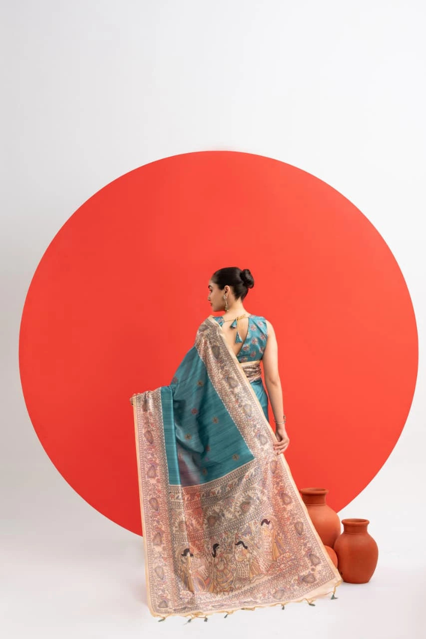 Woman in a blue saree with a red circle background