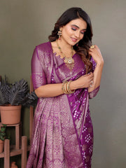 Woman wearing a purple saree with a gray background