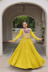 Woman in a yellow traditional outfit standing in an archway.