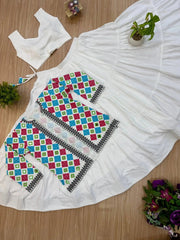 Close-up flat lay of bandhej koti and white tiered lehenga skirt, full 3-piece set view