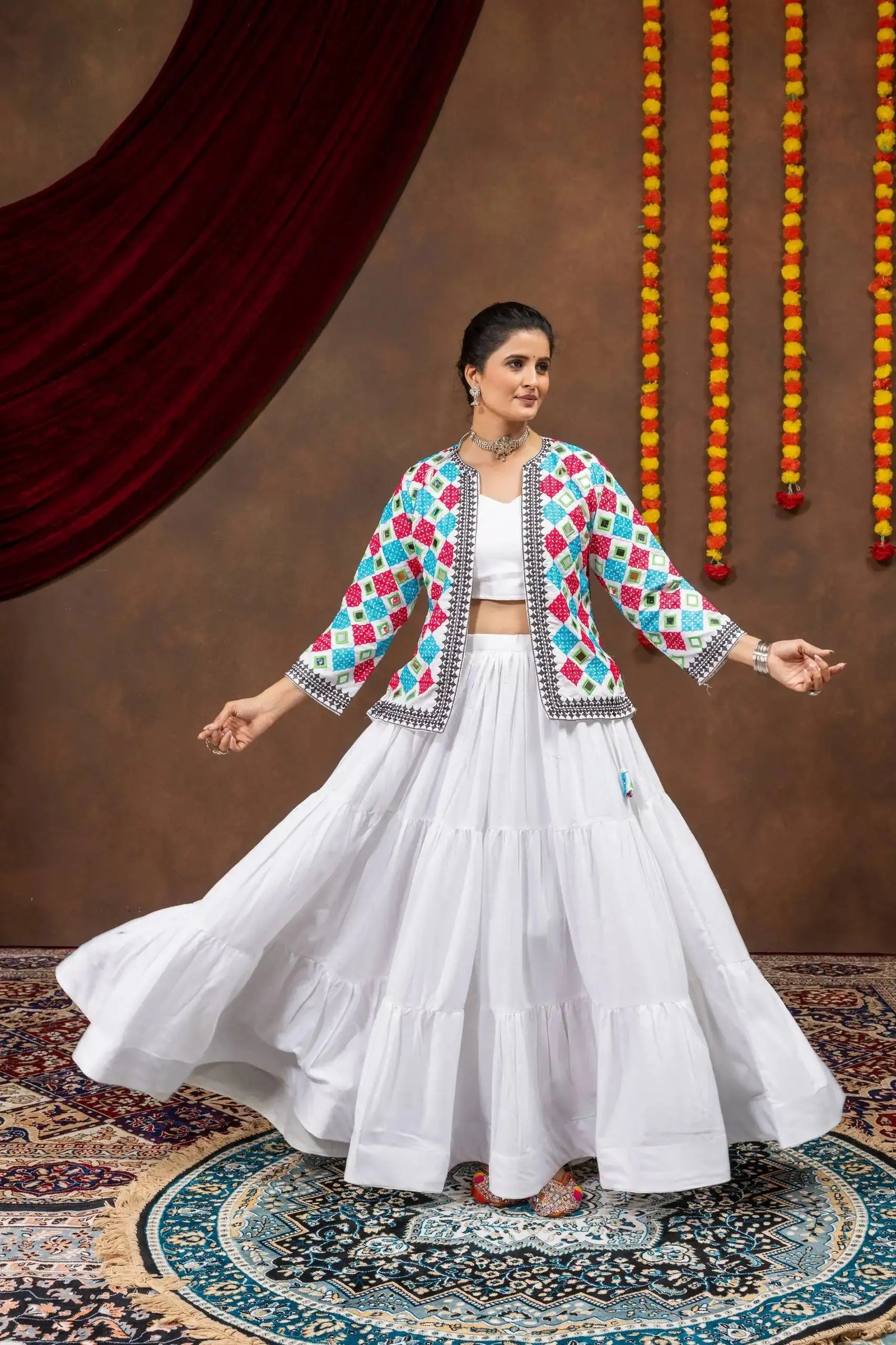 Side twirling view of white 6-meter flair tiered lehenga with bandhej jacket