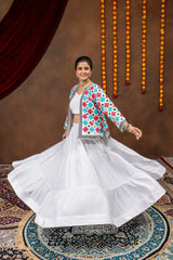 White tiered rayon lehenga twirling in motion with colorful bandhej mirror-work koti